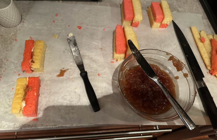 assembly line of cakes and jam and buttercream